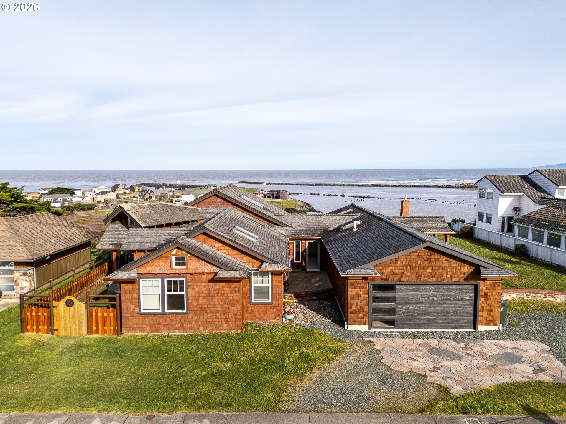 880 Ocean Drive Southwest Bandon, OR 97411 - Photo 1 of 48 an aerial view of a house with a yard