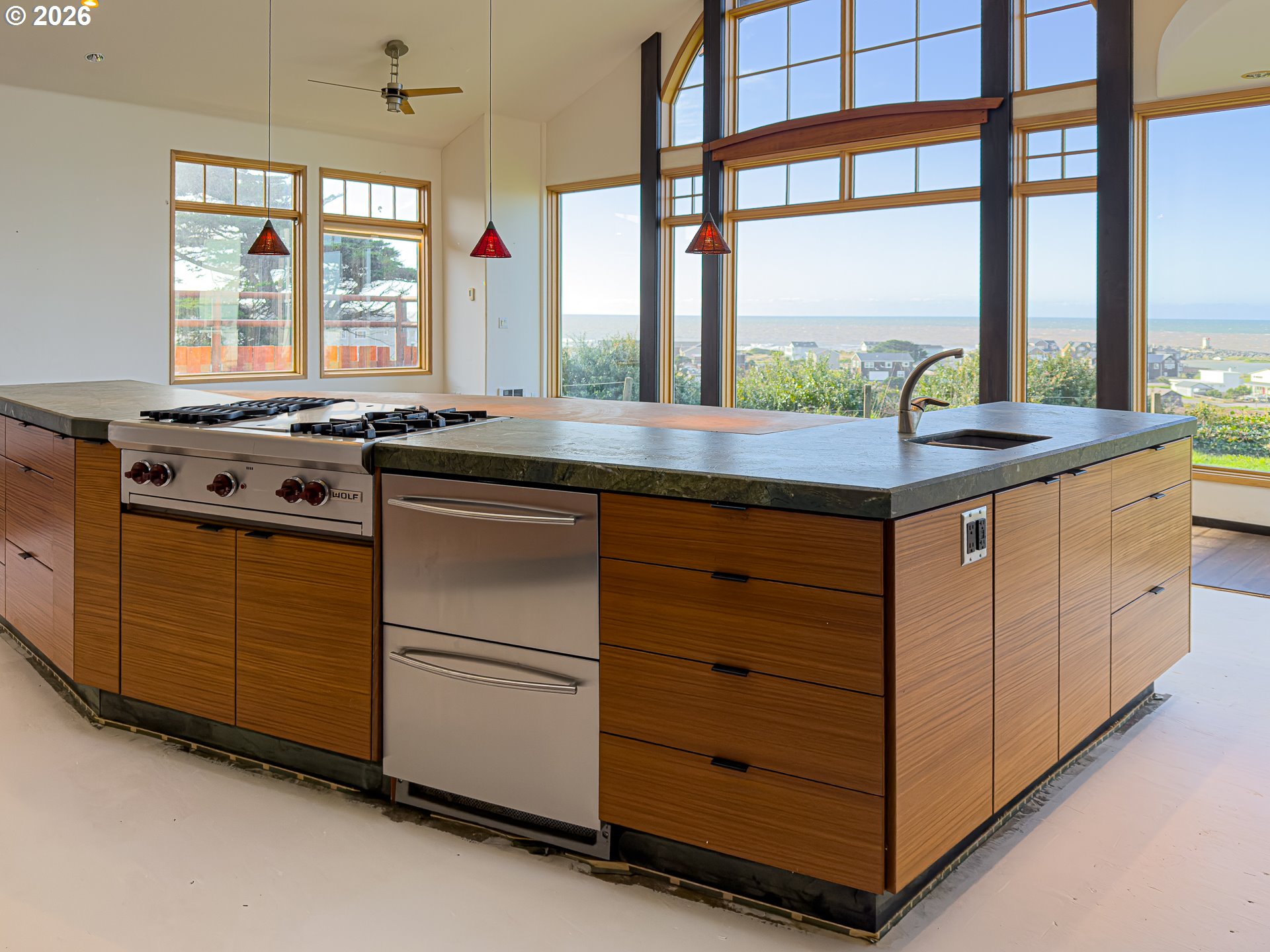 880 Ocean Drive Southwest Bandon, OR 97411 - Photo 15 of 48 a kitchen with granite countertop a stove and a sink