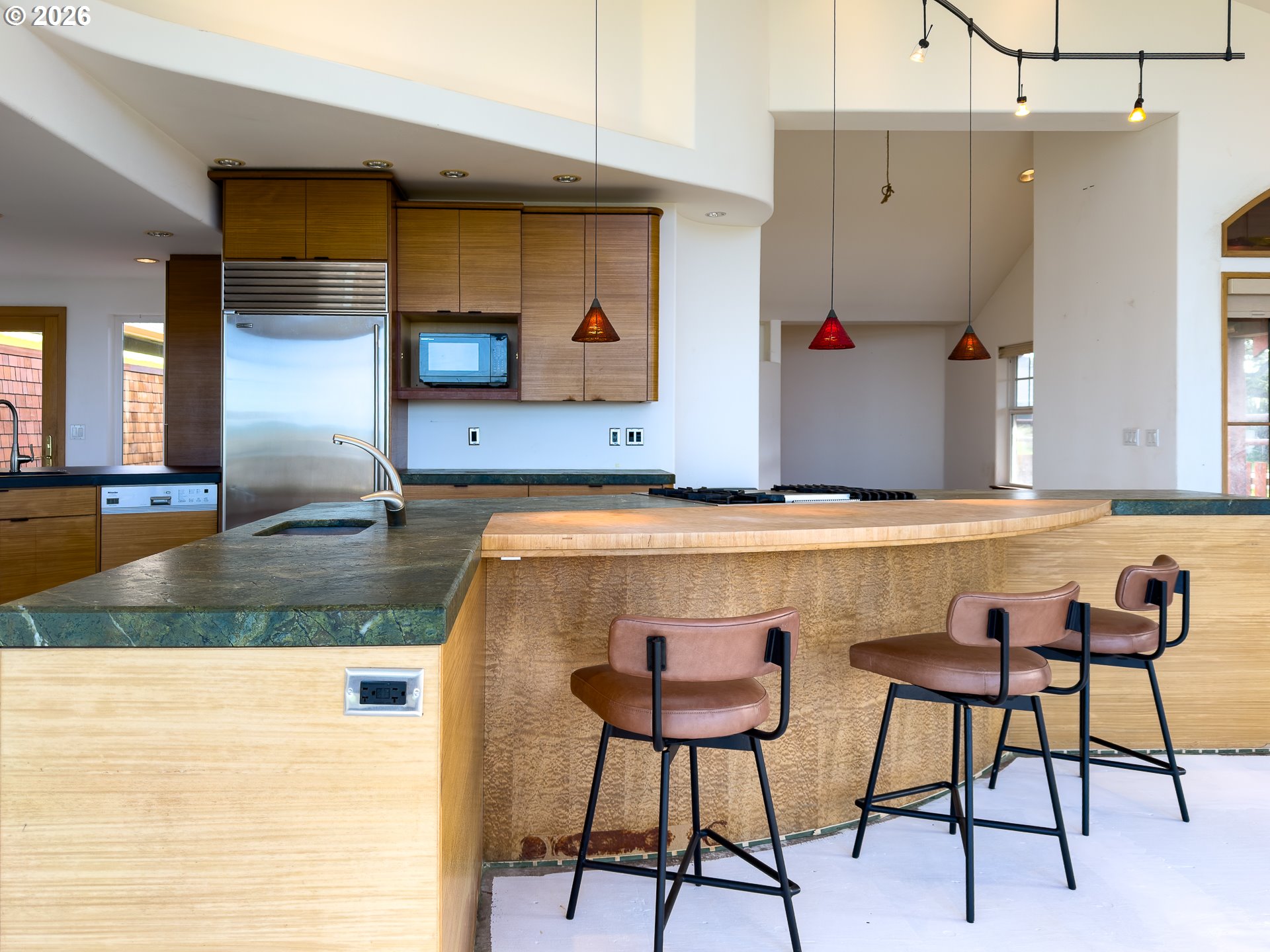 880 Ocean Drive Southwest Bandon, OR 97411 - Photo 16 of 48 a kitchen with a table chairs and a refrigerator