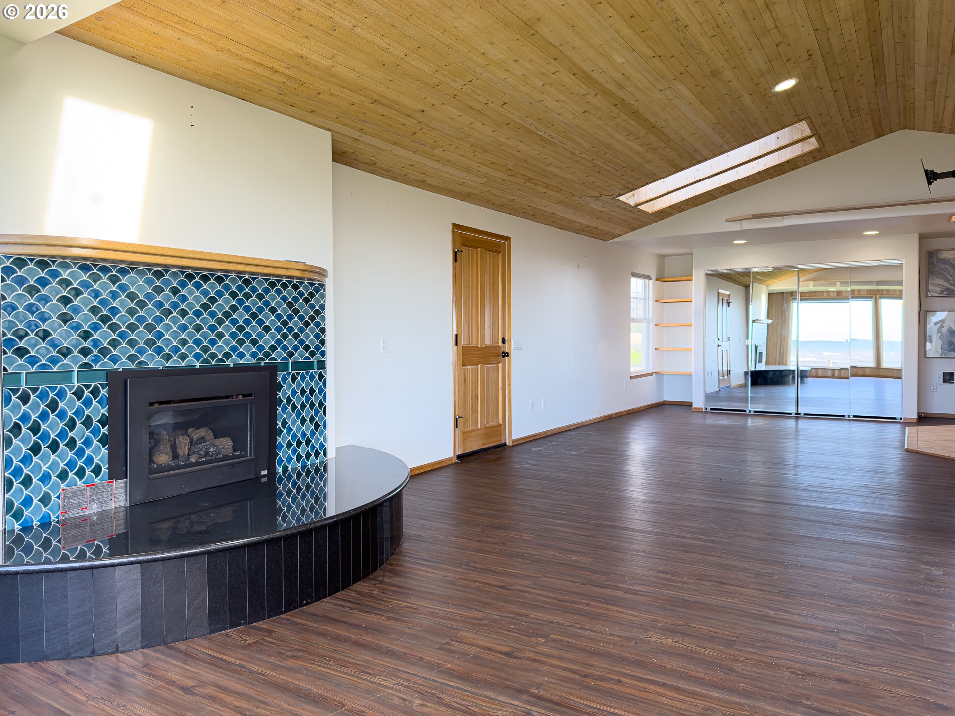 880 Ocean Drive Southwest Bandon, OR 97411 - Photo 24 of 48 a view of a livingroom with wooden floor and a fireplace