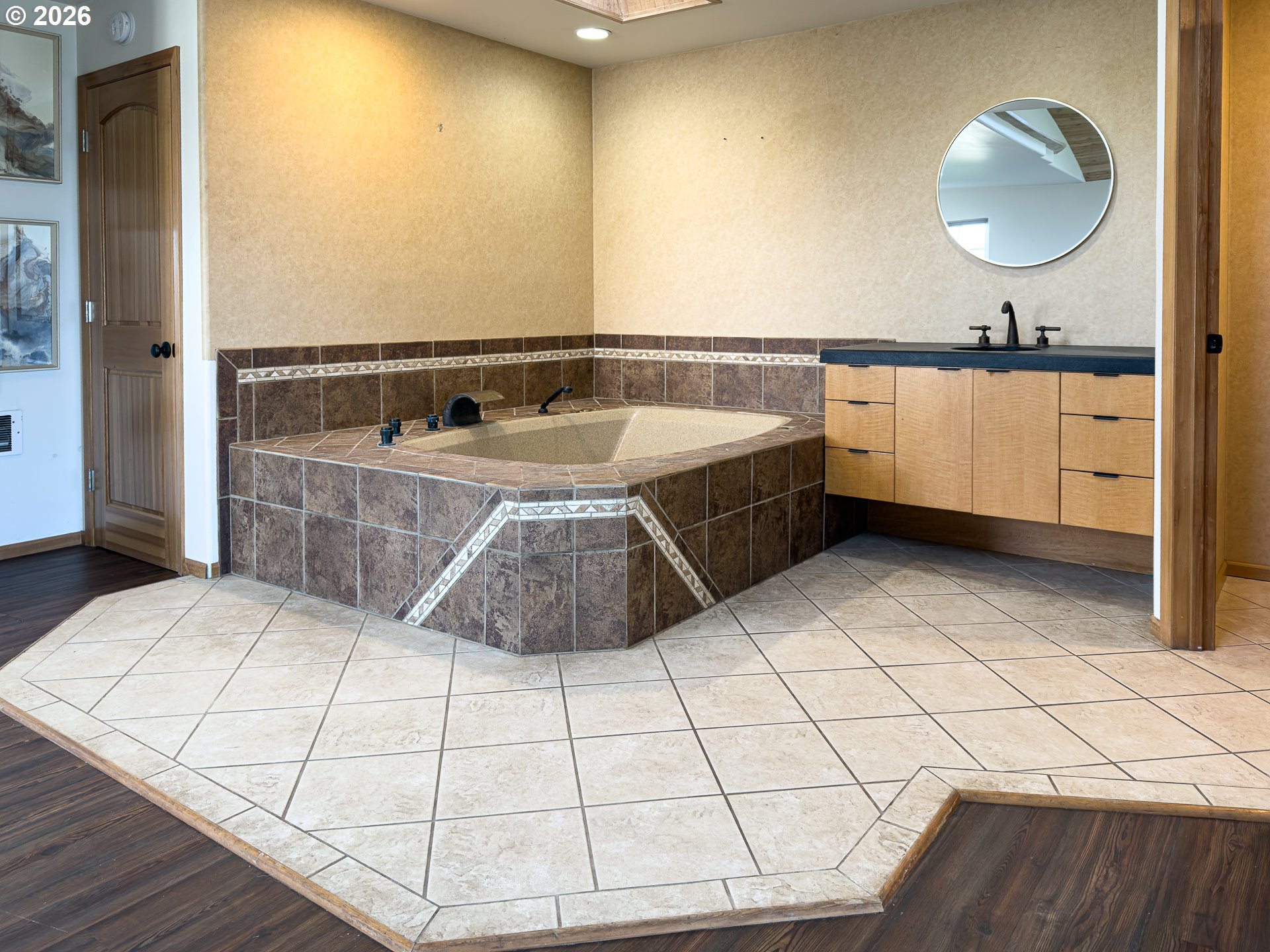 880 Ocean Drive Southwest Bandon, OR 97411 - Photo 27 of 48 a bathroom with a sink a mirror and bathtub