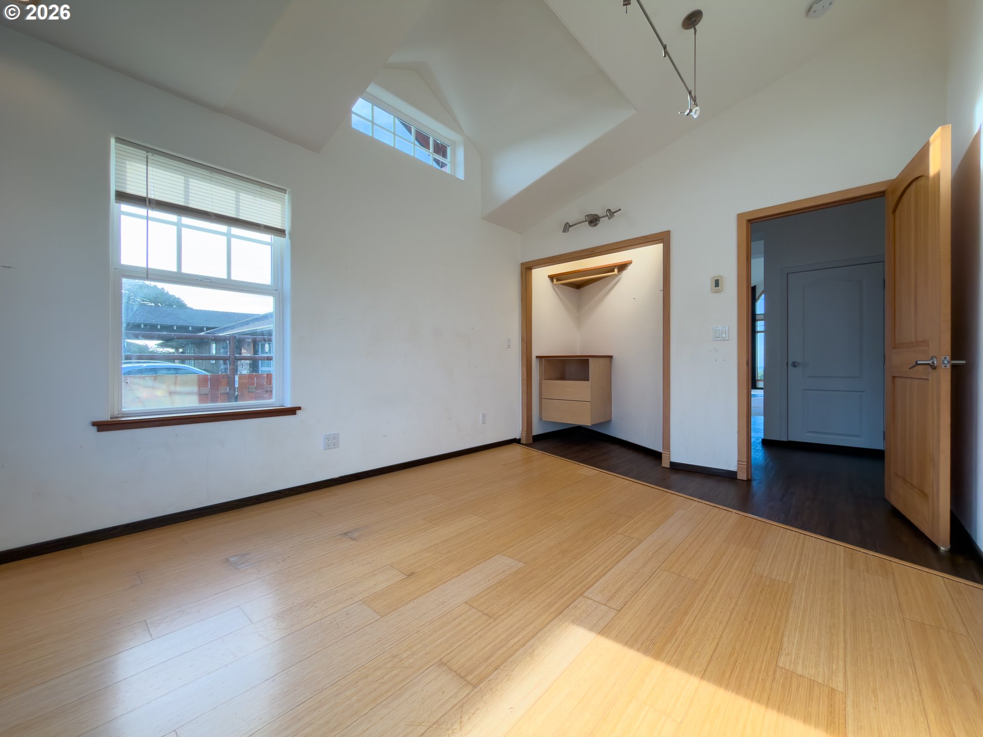 880 Ocean Drive Southwest Bandon, OR 97411 - Photo 32 of 48 a view of an empty room with wooden floor and a window