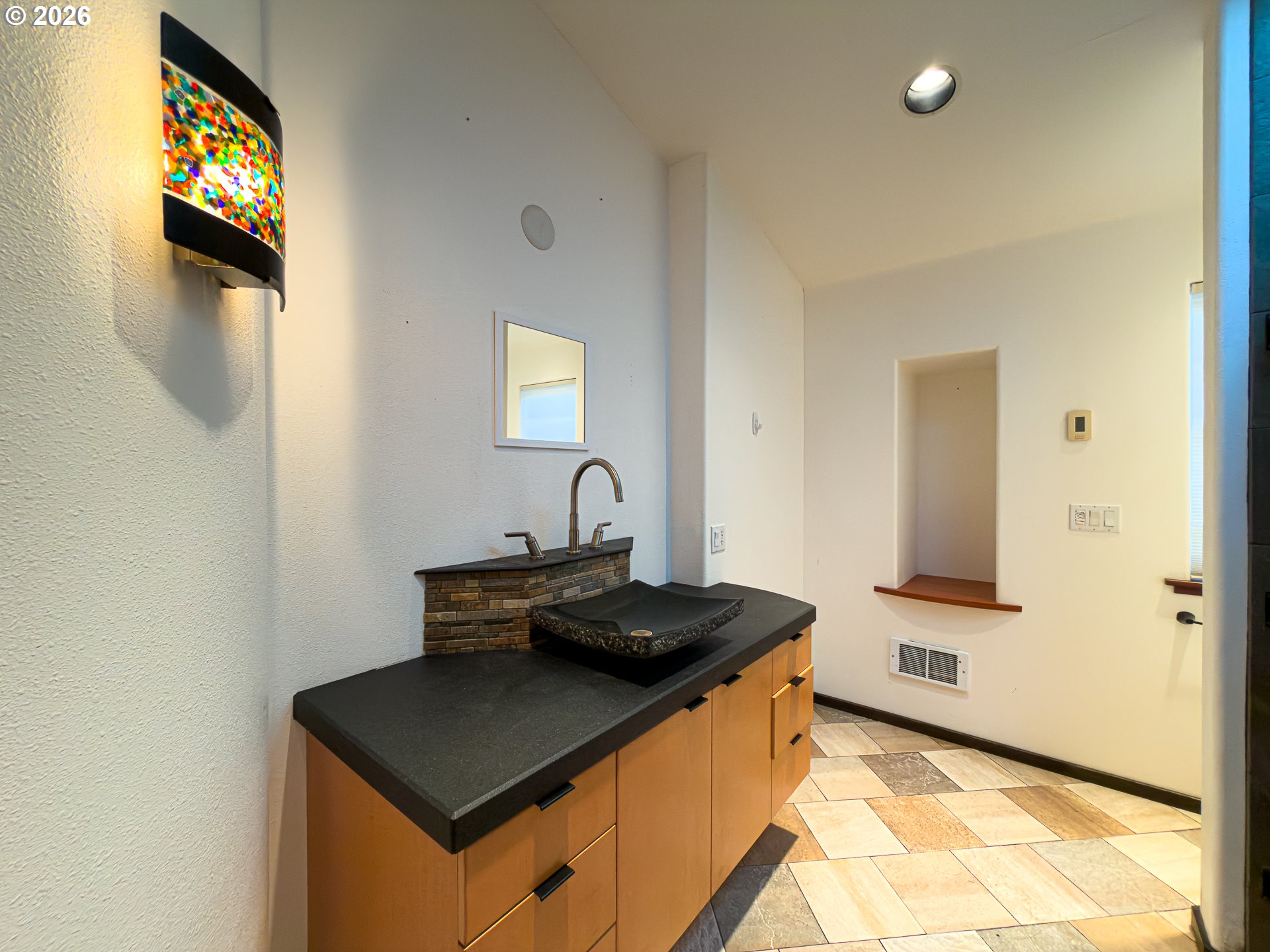 880 Ocean Drive Southwest Bandon, OR 97411 - Photo 33 of 48 a bathroom with a sink a mirror and a bathtub