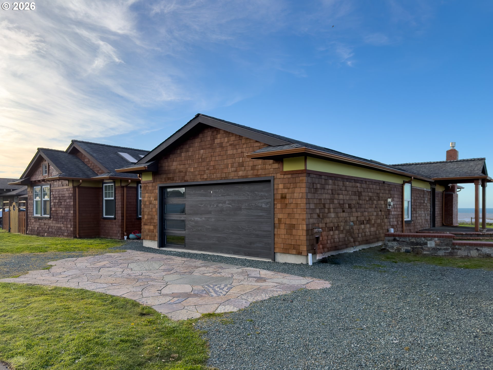 880 Ocean Drive Southwest Bandon, OR 97411 - Photo 7 of 48 a front view of a house with a yard and garage