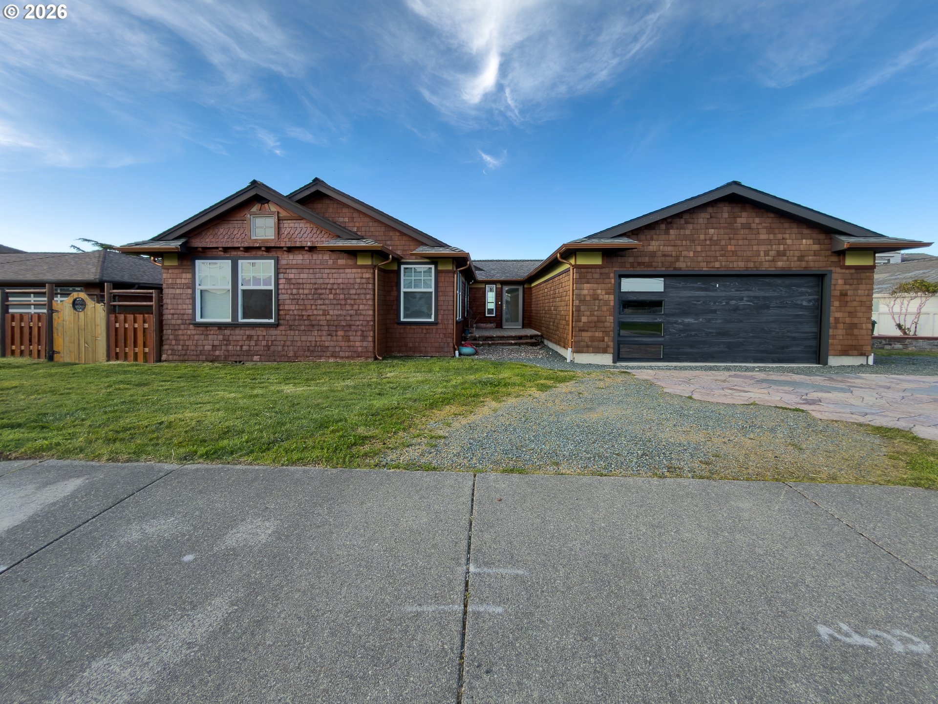 880 Ocean Drive Southwest Bandon, OR 97411 - Photo 8 of 48 a front view of a house with a yard and garage