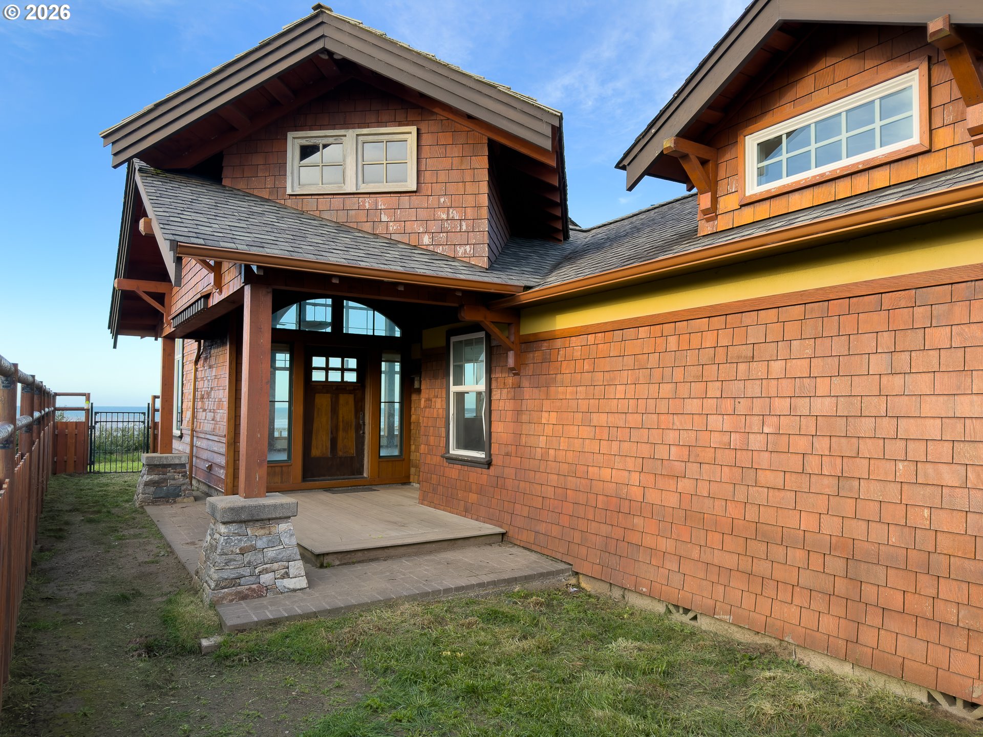 880 Ocean Drive Southwest Bandon, OR 97411 - Photo 9 of 48 a front view of a house with garden