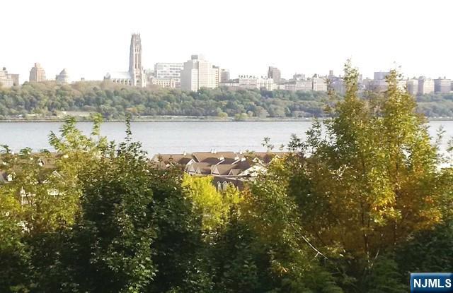 3 Old Wood Road, Unit 2 Edgewater, NJ 07020 - Photo 1 of 10 a view of a lake with a city