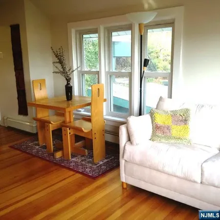 a living room with furniture wooden floor and a fireplace