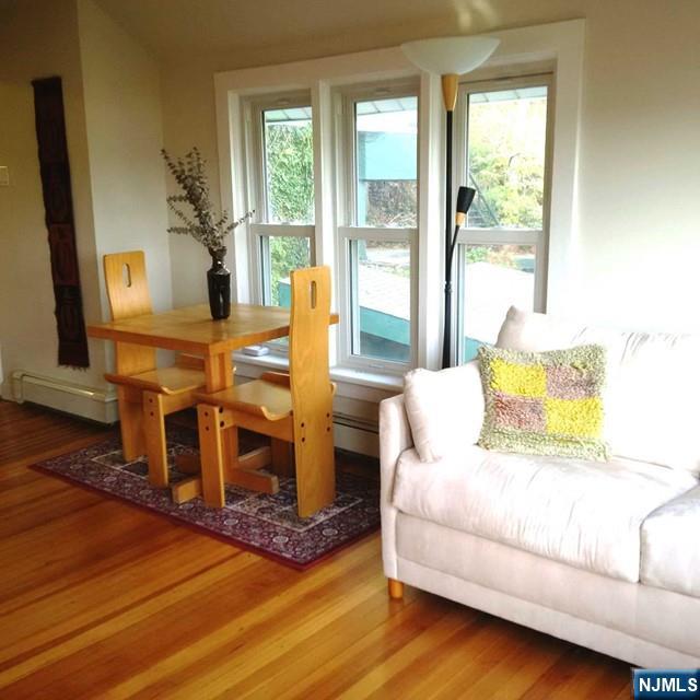 3 Old Wood Road, Unit 2 Edgewater, NJ 07020 - Photo 3 of 10 a living room with furniture wooden floor and a fireplace