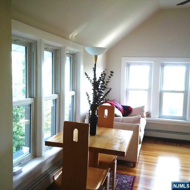 3 Old Wood Road, Unit 2 Edgewater, NJ 07020 - Photo 4 of 10 a view of a dining room with furniture window and wooden floor