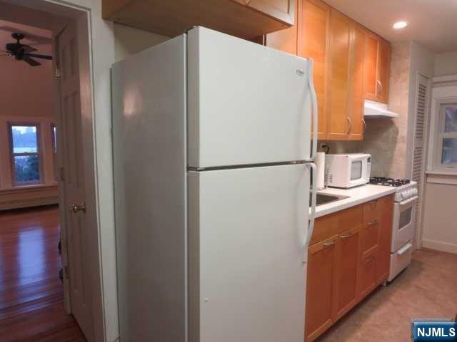 3 Old Wood Road, Unit 2 Edgewater, NJ 07020 - Photo 5 of 10 a white refrigerator freezer sitting in a kitchen