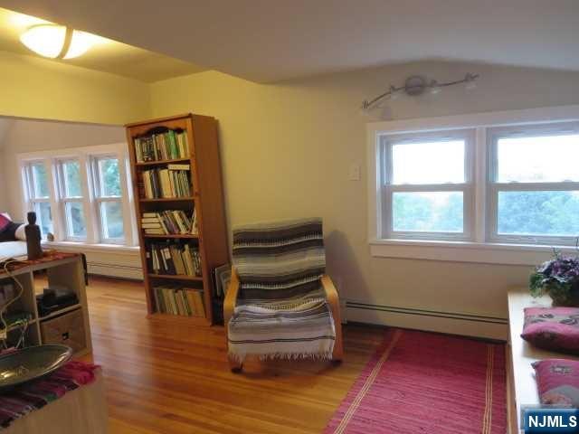 3 Old Wood Road, Unit 2 Edgewater, NJ 07020 - Photo 6 of 10 a living room with furniture and a book shelf