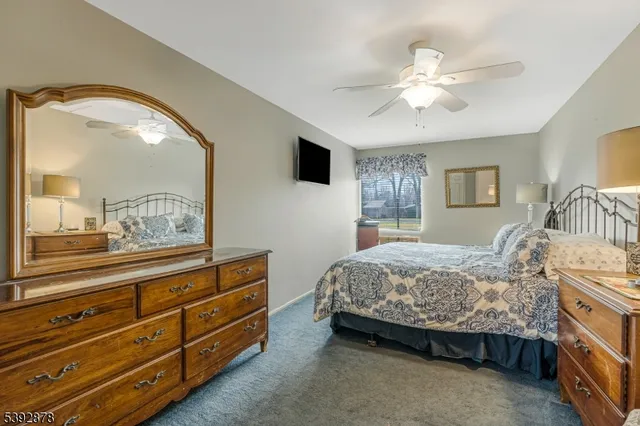 a bedroom with a bed and a mirror on dresser