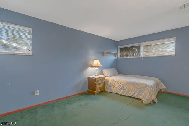 a bedroom with a bed and a lamp on table