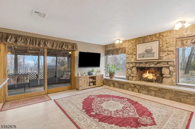 a living room with fireplace furniture and a flat screen tv