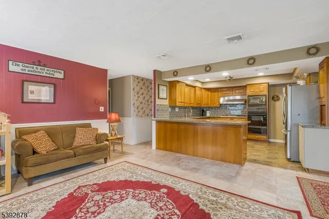 a living room with furniture and kitchen view