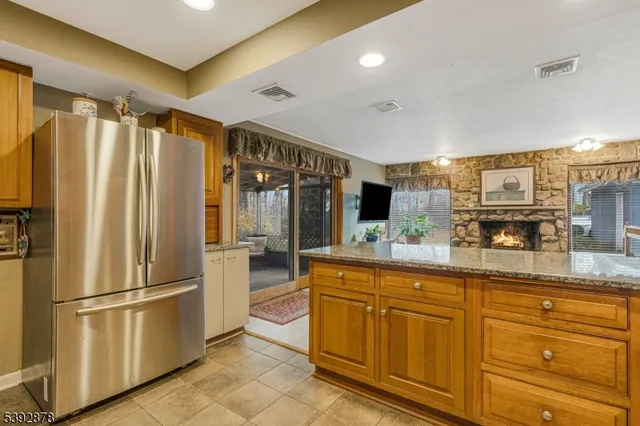 a kitchen with stainless steel appliances granite countertop a refrigerator and a sink