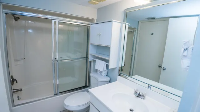 a bathroom with a sink toilet and shower