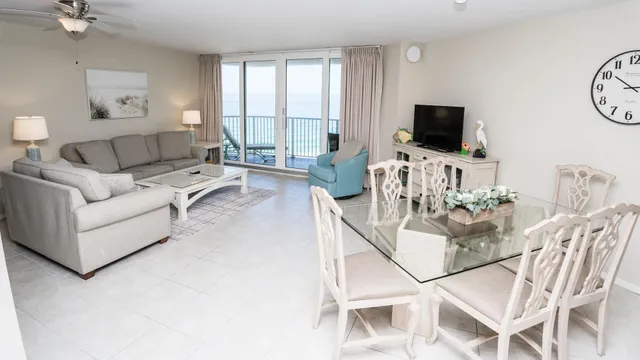 a living room with furniture a flat screen tv and a window