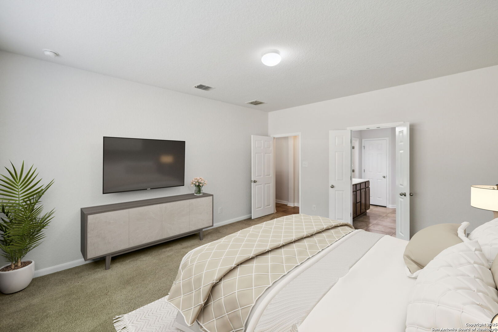 23567 7 Winds San Antonio, TX 78258 - Photo 12 of 49 a bedroom with a bed and a flat screen tv