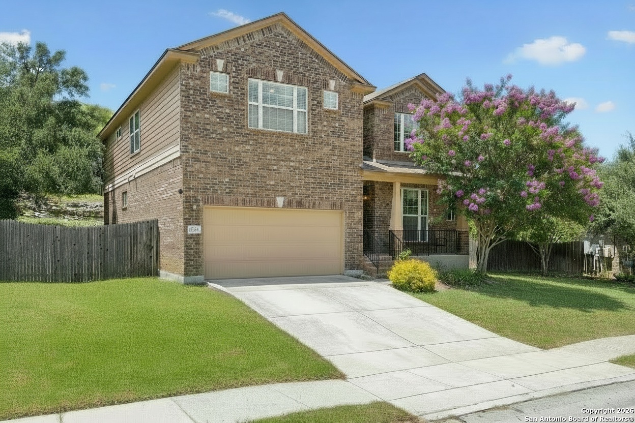 23567 7 Winds San Antonio, TX 78258 - Photo 2 of 49 a front view of a house with garden