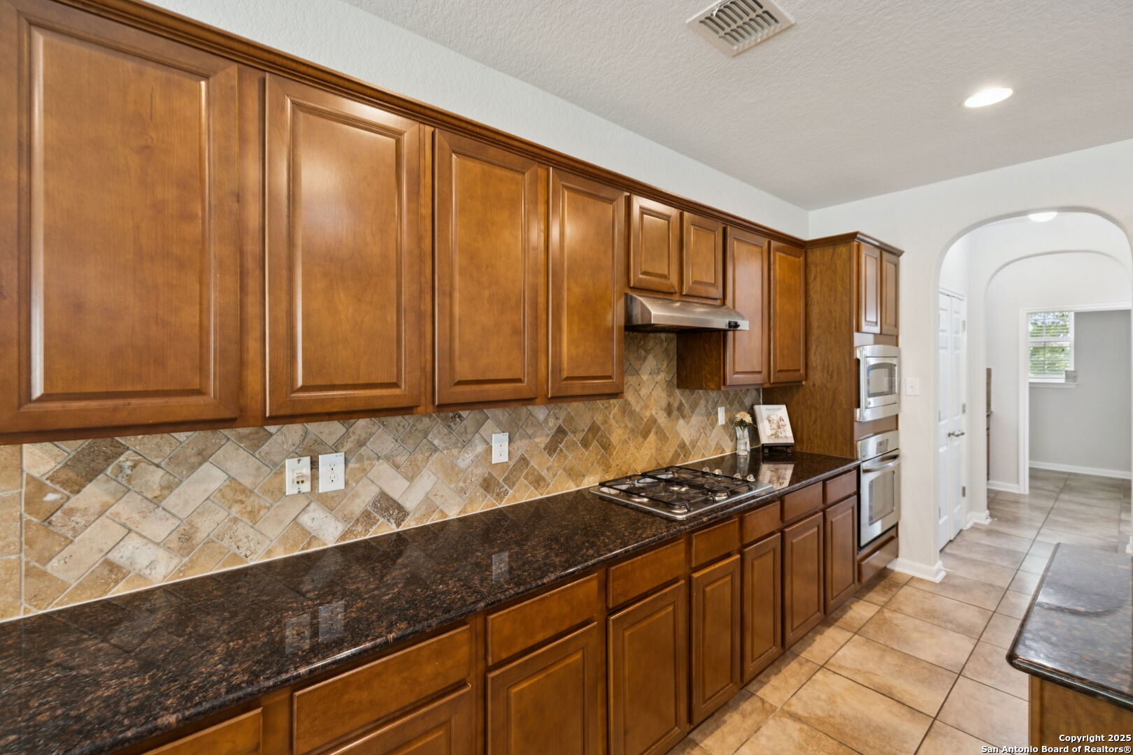 23567 7 Winds San Antonio, TX 78258 - Photo 21 of 49 a kitchen with granite countertop cabinets and black appliances