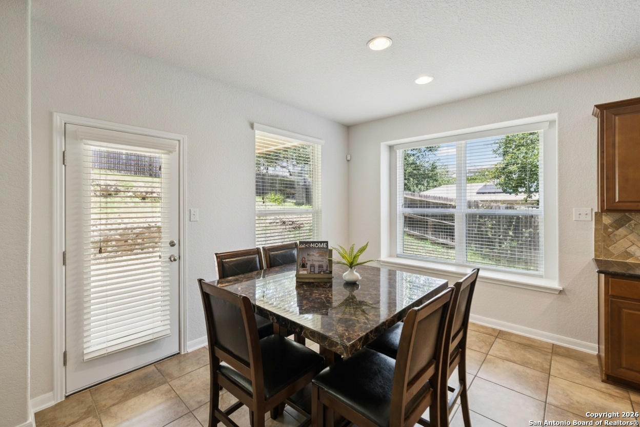23567 7 Winds San Antonio, TX 78258 - Photo 23 of 49 a view of a dining room with furniture and wooden floor