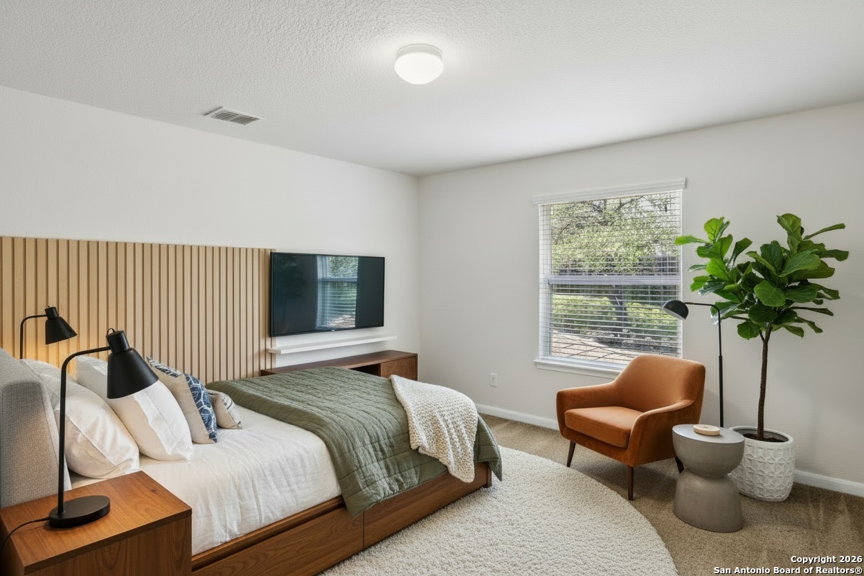 23567 7 Winds San Antonio, TX 78258 - Photo 32 of 49 a bedroom with furniture and a large window