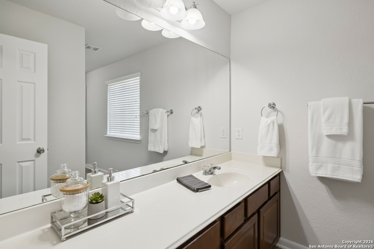 23567 7 Winds San Antonio, TX 78258 - Photo 35 of 49 a bathroom with a sink vanity and a mirror