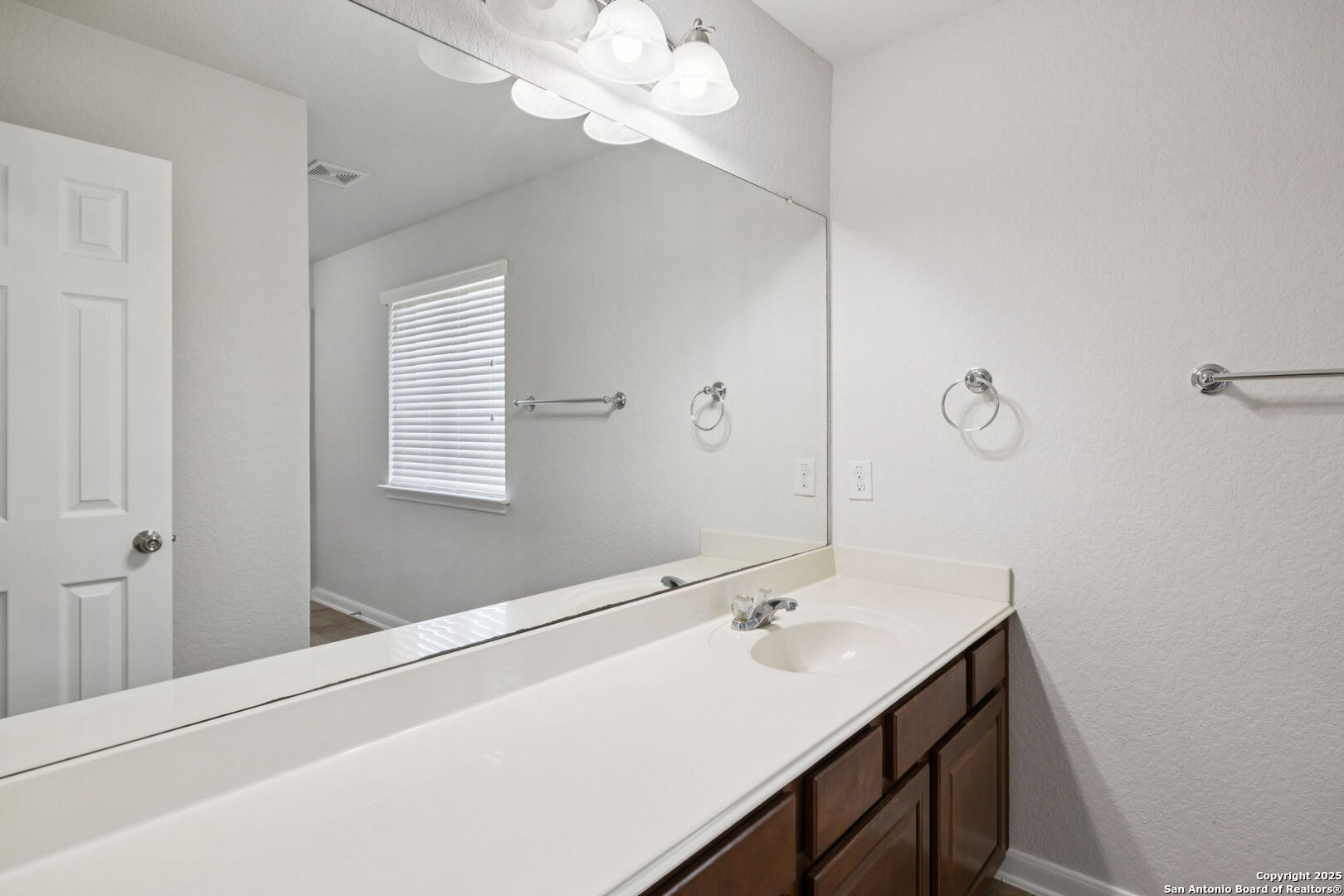 23567 7 Winds San Antonio, TX 78258 - Photo 36 of 49 a bathroom with a sink vanity and a mirror