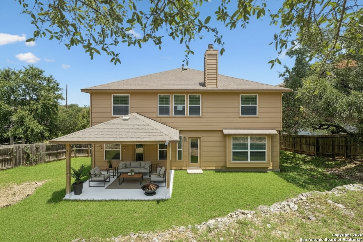 23567 7 Winds San Antonio, TX 78258 - Photo 41 of 49 a front view of a house with a yard table and chairs