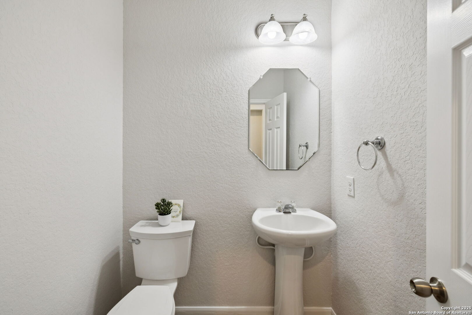 23567 7 Winds San Antonio, TX 78258 - Photo 10 of 49 a bathroom with a toilet sink and mirror