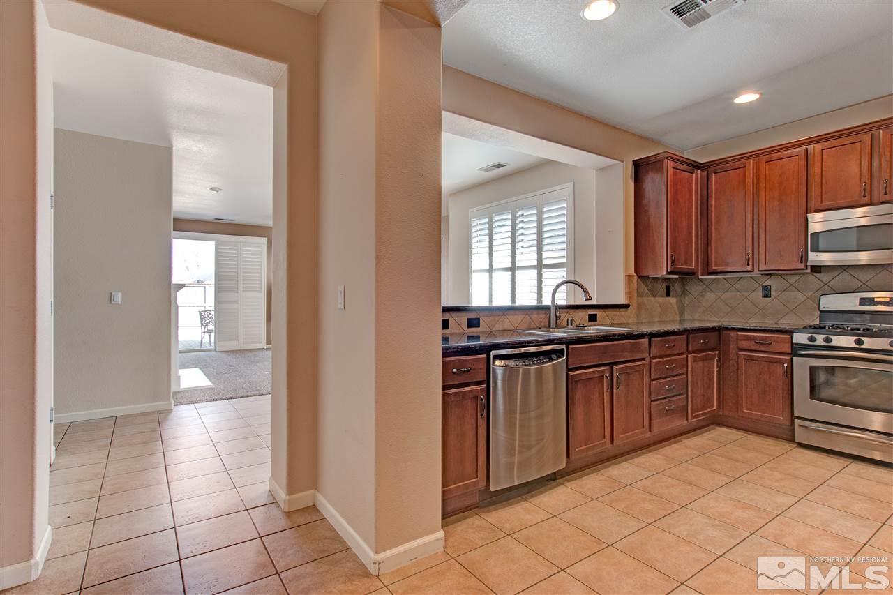 475 Dartmoor Court Reno, NV 89521 - Photo 11 of 35 a kitchen with stainless steel appliances granite countertop a stove a sink and a refrigerator
