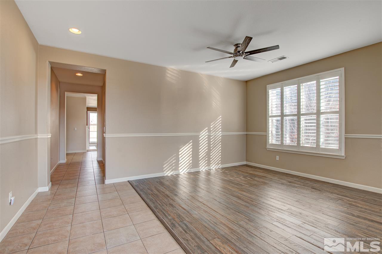 475 Dartmoor Court Reno, NV 89521 - Photo 4 of 35 an empty room with wooden floor fan and windows