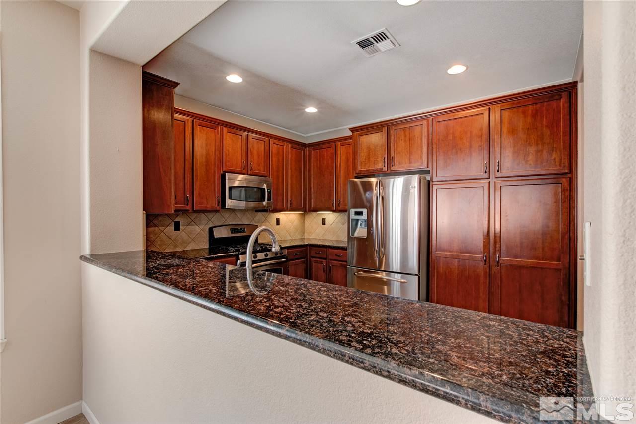 475 Dartmoor Court Reno, NV 89521 - Photo 6 of 35 a kitchen with stainless steel appliances granite countertop a refrigerator sink and microwave