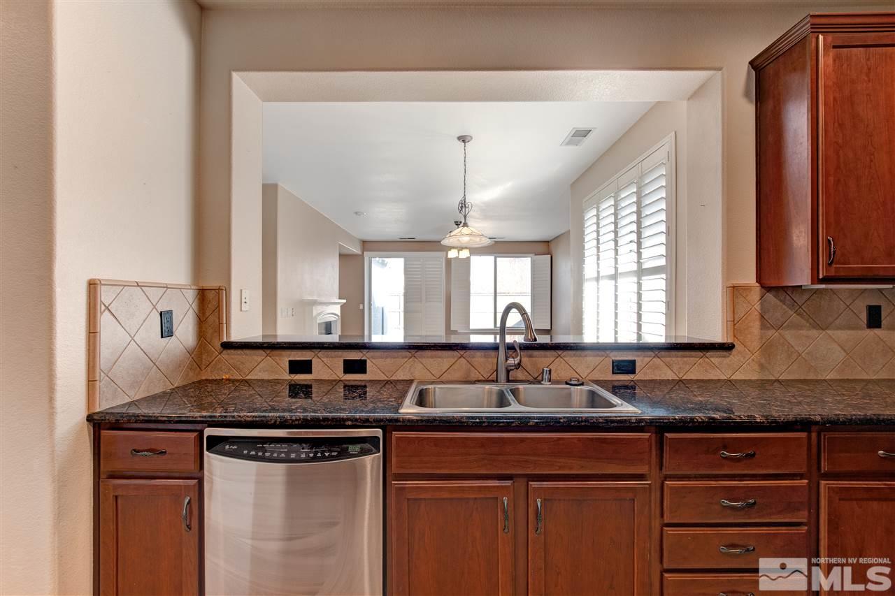 475 Dartmoor Court Reno, NV 89521 - Photo 7 of 35 a kitchen with granite countertop a sink and a granite counter tops