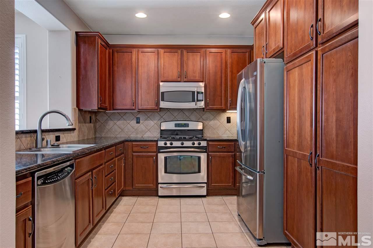 475 Dartmoor Court Reno, NV 89521 - Photo 9 of 35 a kitchen with stainless steel appliances granite countertop a stove a refrigerator and a sink