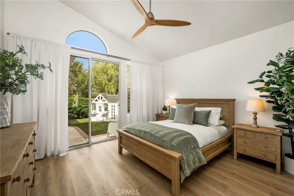 a bedroom with a large bed and a potted plant