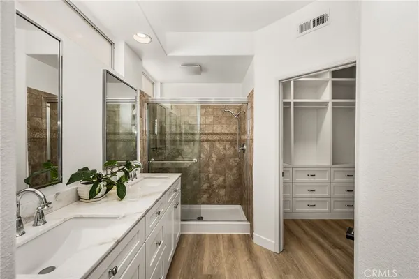 a bathroom with a shower sink and mirror