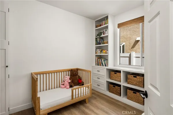 a view of a hallway to a livingroom with furniture and wooden floor