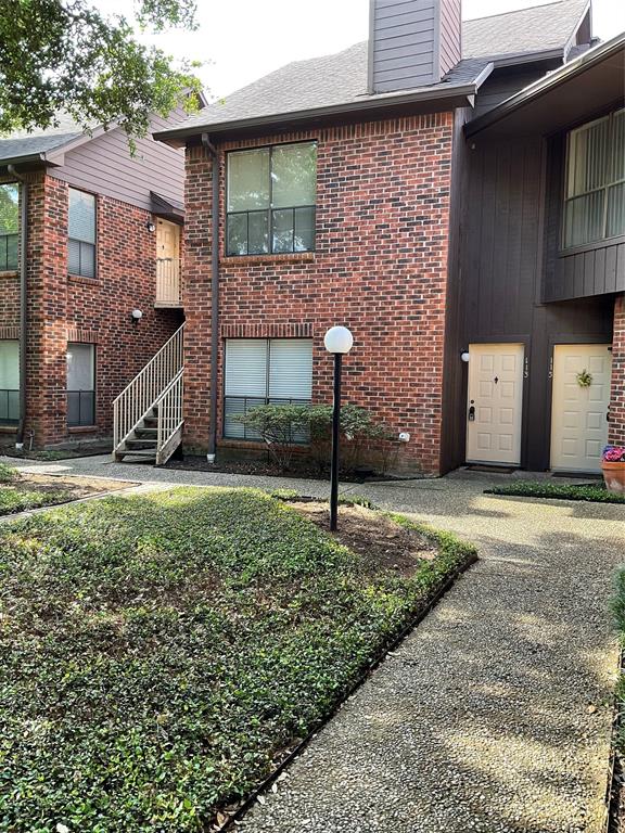3100 Walnut Bend Lane, Unit 113 Houston, TX 77042 - Photo 1 of 20 a front view of a house with a yard