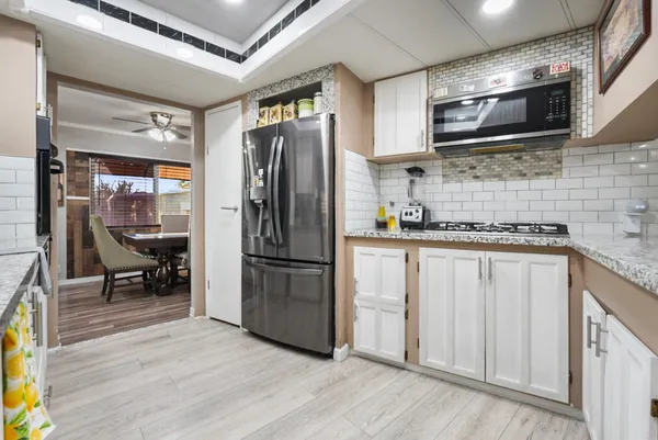 a kitchen with counter top space and stainless steel appliances