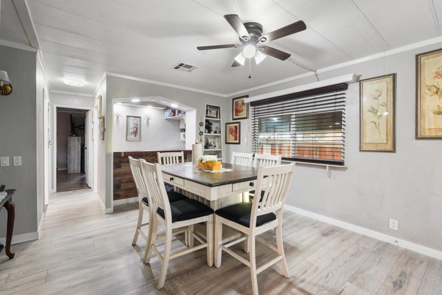 4837 Faith Home Road, Unit 162 Ceres, CA 95307 - Photo 17 of 45 a view of a dining room with furniture window and wooden floor