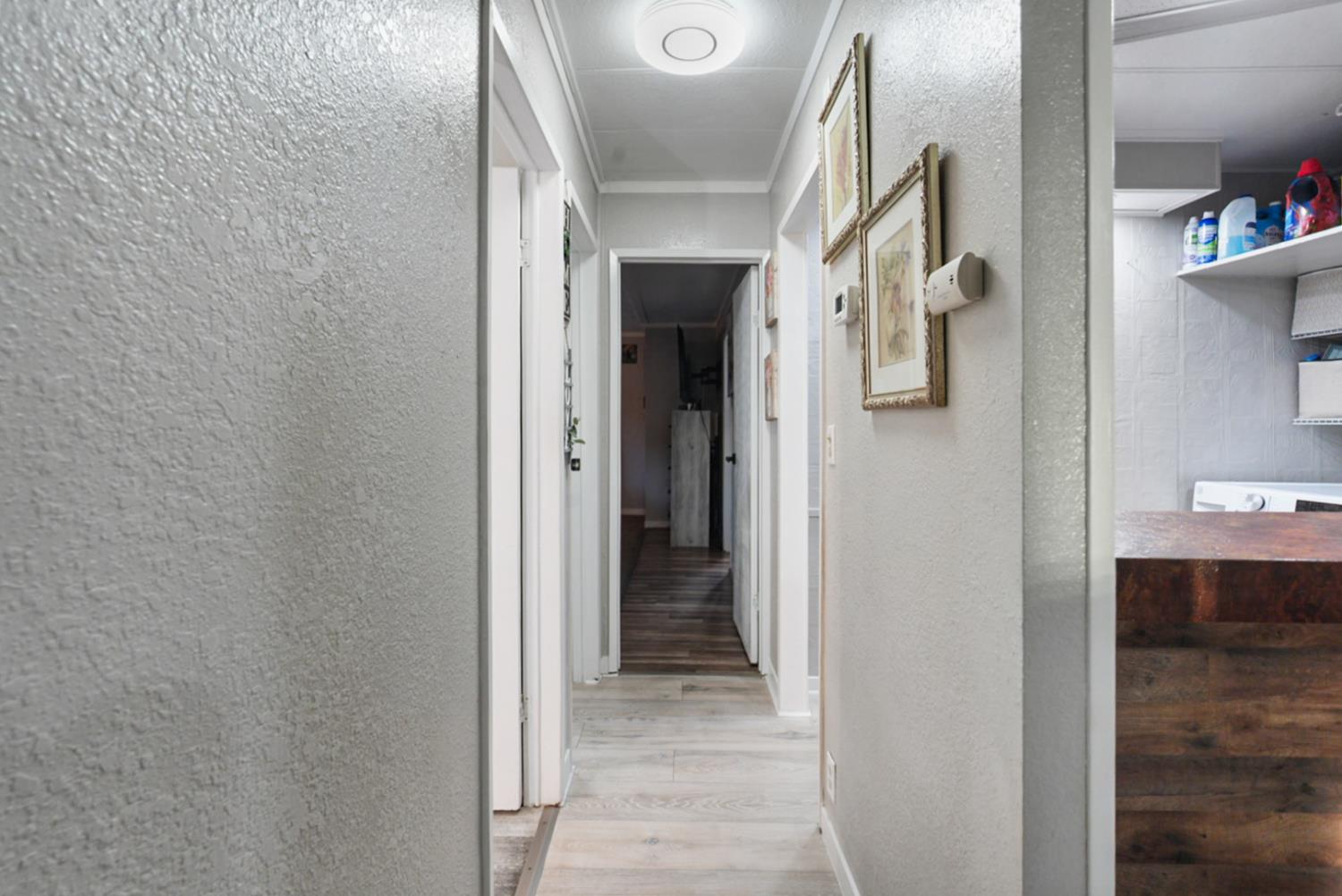 4837 Faith Home Road, Unit 162 Ceres, CA 95307 - Photo 18 of 45 a view of a hallway with wooden shelves