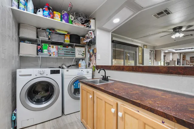a bedroom with a large bed and a chandelier fan