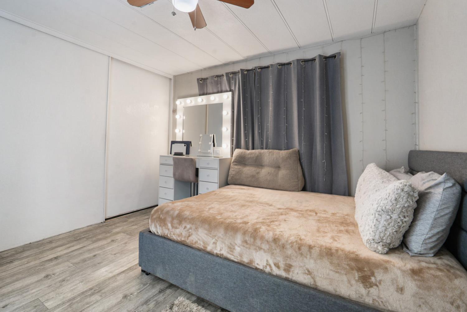 4837 Faith Home Road, Unit 162 Ceres, CA 95307 - Photo 20 of 45 a bedroom with a bed and wooden floor