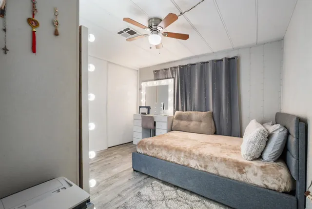 a bathroom with a granite countertop toilet sink and mirror