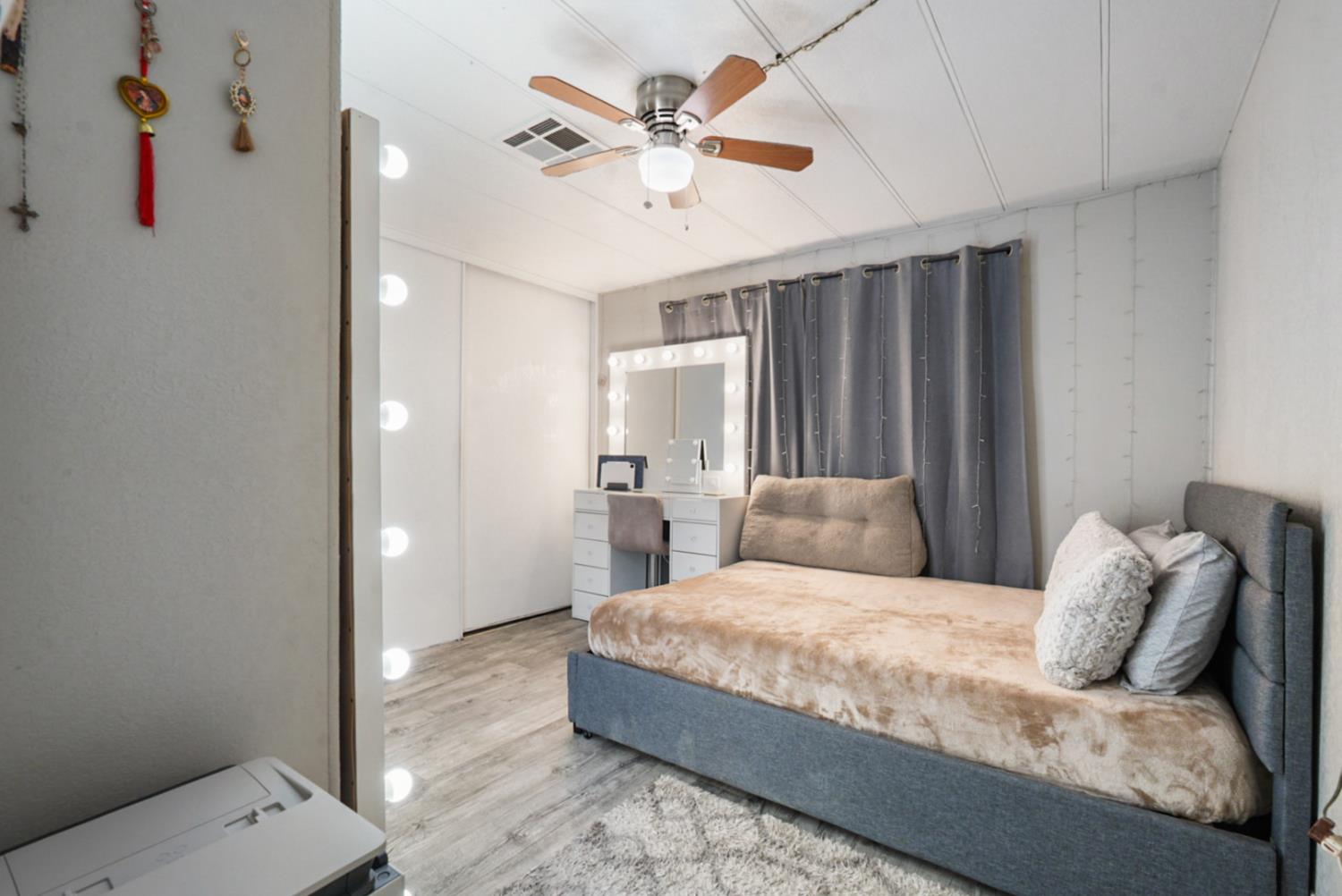 4837 Faith Home Road, Unit 162 Ceres, CA 95307 - Photo 21 of 45 a bedroom with a large bed and a chandelier fan