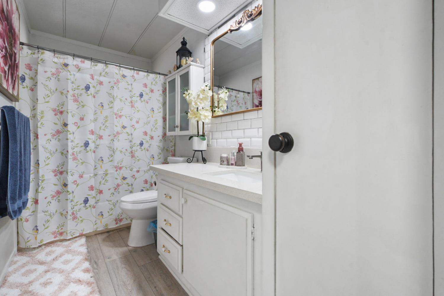 4837 Faith Home Road, Unit 162 Ceres, CA 95307 - Photo 23 of 45 a bathroom with a granite countertop toilet sink and mirror