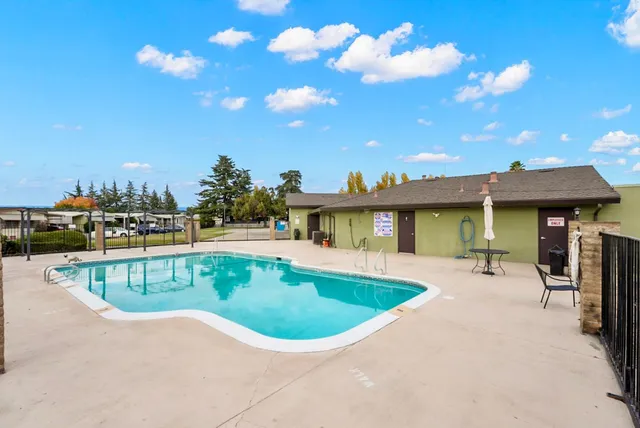 an aerial view of a house with swimming pool and outdoor space